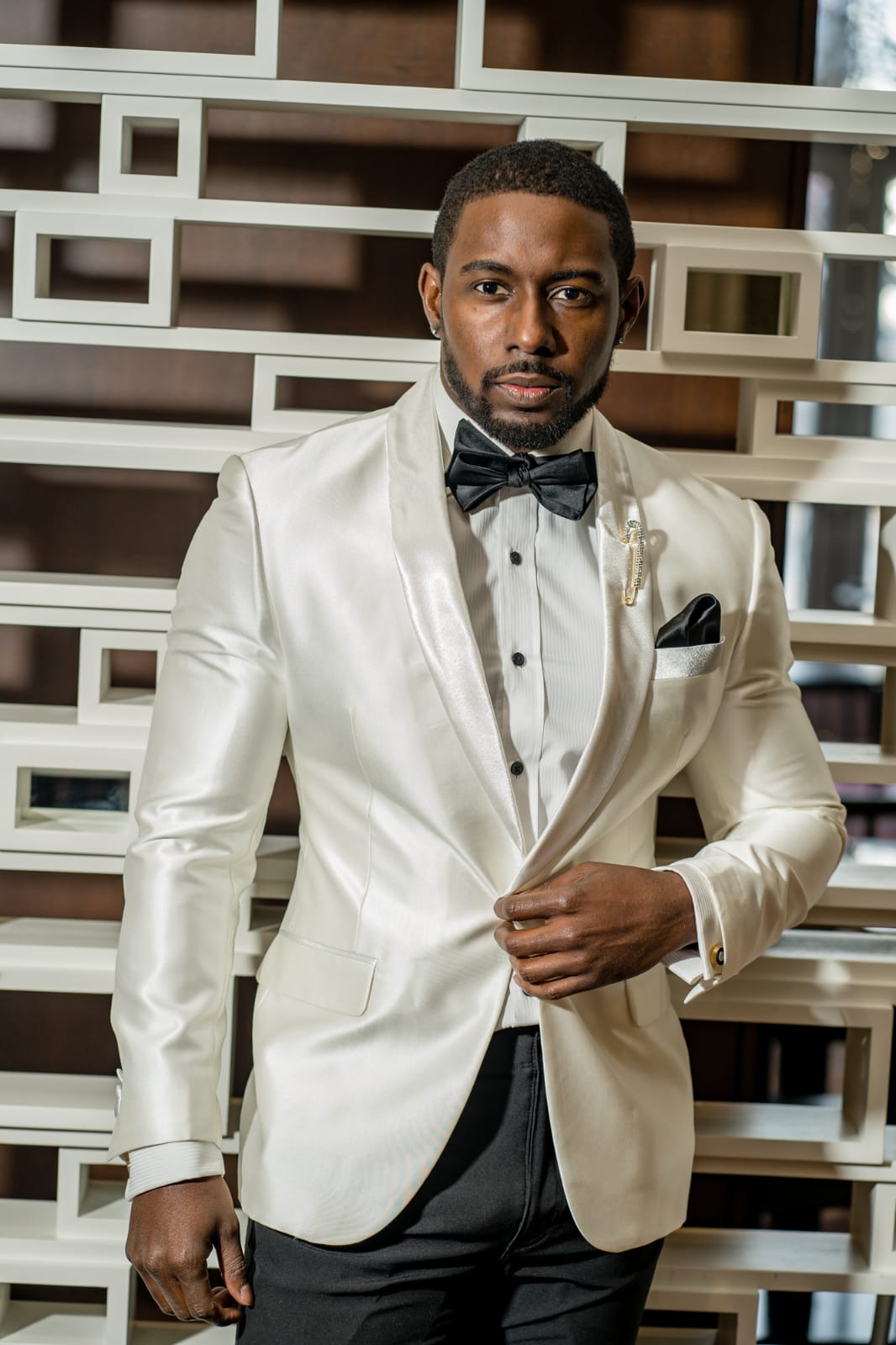 Slim-fit ivory suit jacket with black pants and shawl lapel